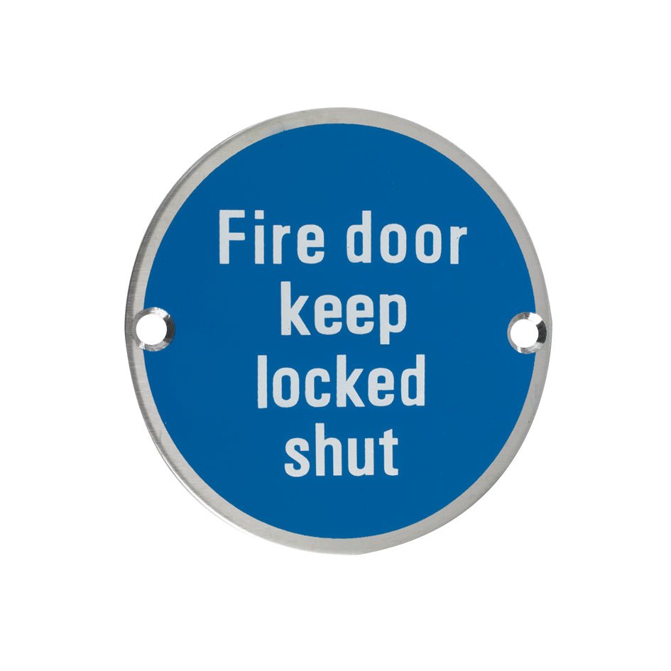 Zoo Hardware Fire Door Keep Locked Shut Sign in blue, featuring white text on a circular metal base with two mounting holes.