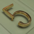 Brass bee Premium Floating Plain House Numbers in Polished Brass Finish 0-9, featuring a sleek design with a reflective surface, shown from an angled perspective to highlight the clean lines and modern style.