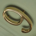 Brass bee Premium Floating Plain House Numbers in polished brass finish, featuring a sleek design with rounded edges, visible mounting post, and an open back for a stylish look. This set includes numbers 0-9.