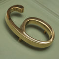 Brass bee Premium Floating Plain House Number 6 in polished brass finish, featuring a smooth, rounded design with a sleek surface and two mounting pins for installation.
