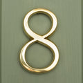 Brass bee Premium Floating Plain House Number in polished brass finish, displaying the number 8 with a smooth, reflective surface, mounted against a green background.