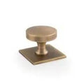 Alexander & Wilks Bullion Cupboard Knob on Square Backplate in a brushed antique brass finish, featuring a round knob atop a square backplate.