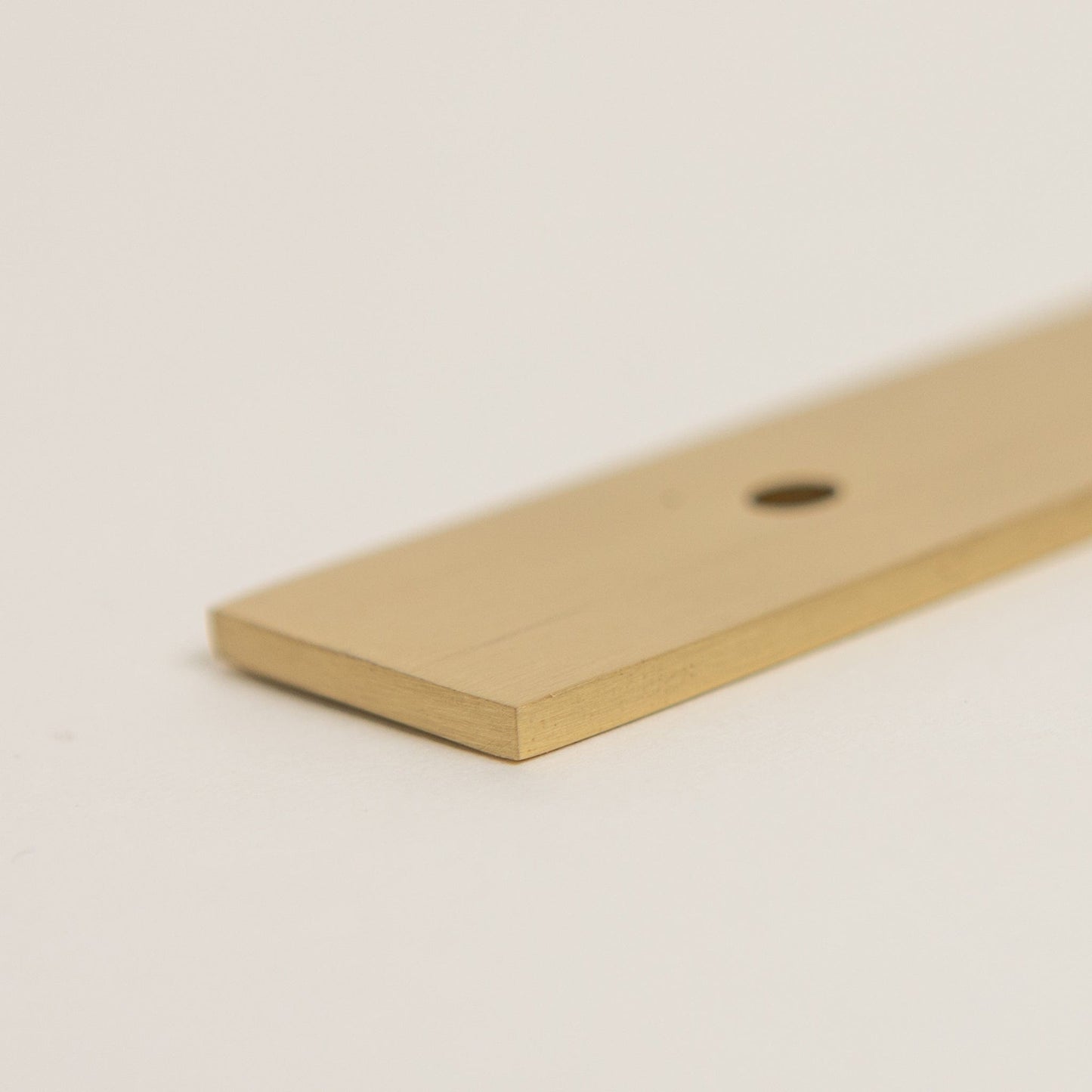 Brass bee Brass Backplate in satin brass with a smooth rectangular shape, featuring a 128mm/160mm hole-to-hole design. The backplate is made of solid brass and showcases a brushed finish for a subtle sheen.
