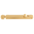 Carlisle Brass Surface Bolt in a polished brass finish, featuring a slender rectangular body with a rounded thumb turn for locking.