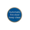 Atlantic Comercial Hardware circular sign in blue with white text that reads "Automatic fire door keep clear." The sign is designed for visibility and compliance.