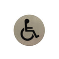 Atlantic Comercial Hardware round sign in brushed metal finish with a black wheelchair accessibility symbol, indicating compliance with accessibility standards.