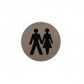 Atlantic Comercial Hardware round restroom sign featuring two figures, a man and a woman, depicted in black against a brushed metal background.