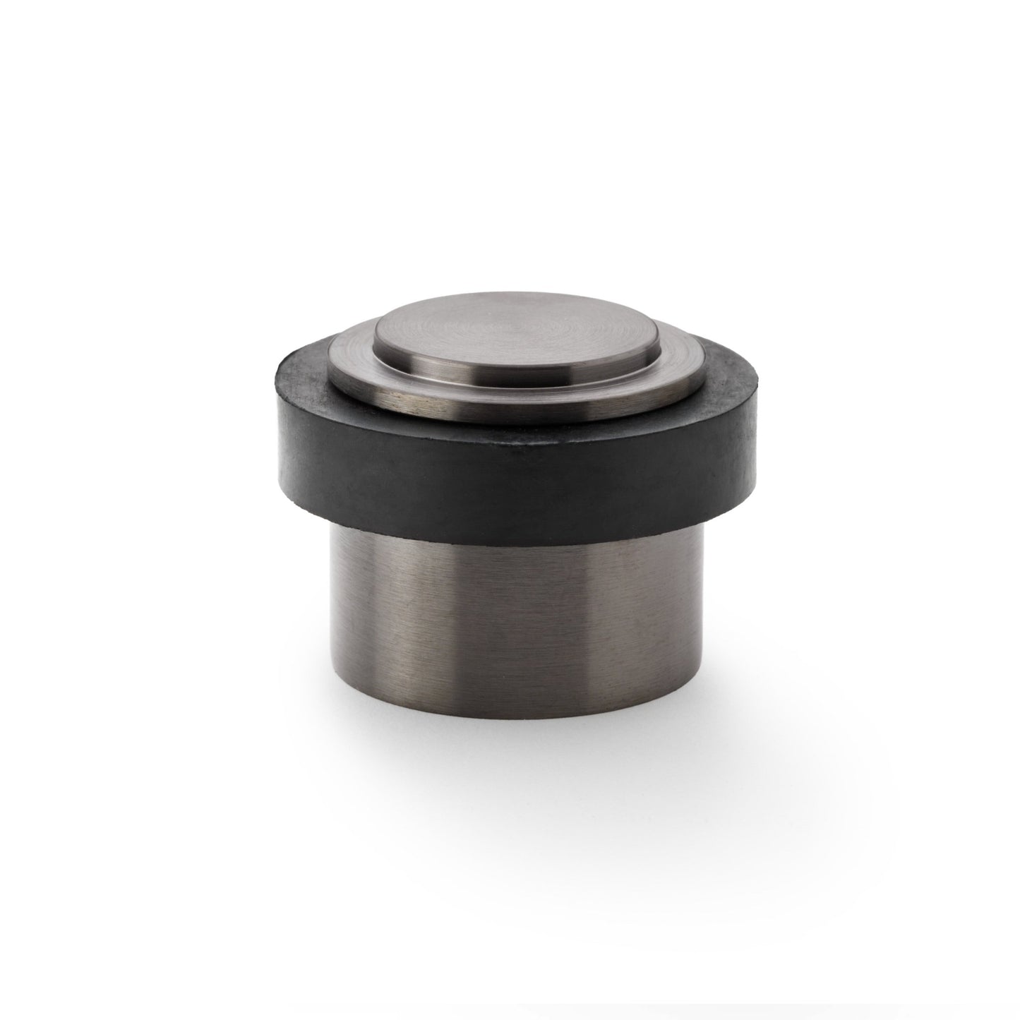Alexander & Wilks Plain Floor Mounted Door Stop featuring a cylindrical base with a metallic finish and a black rubber ring, designed to provide sturdy door protection and prevent wall damage.