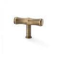 Alexander & Wilks Crispin Bamboo T-Bar Cupboard Knob in brushed antique brass, featuring a distinctive T-bar shape and smooth finish for cabinet and drawer applications.