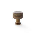 Alexander & Wilks Lucia Knurled Cupboard Knob in a brass finish, featuring a textured knurled design on the sides and a smooth top, suitable for cabinets and drawers.