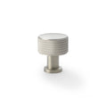 Alexander & Wilks Lucia Knurled Cupboard Knob in a brushed nickel finish, featuring a textured knurled design and a round shape, suitable for cabinets or drawers.