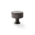 Alexander & Wilks Lucia Knurled Cupboard Knob in dark metal finish, featuring a round top with a textured knurled design and a cylindrical base for easy installation.