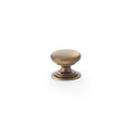 Alexander & Wilks Waltz Round Cupboard Knob on Stepped Rose in antique brass finish, featuring a smooth round shape and a stepped base for a classic design.
