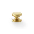 Alexander & Wilks Waltz Round Cupboard Knob on Stepped Rose in brushed brass, featuring a smooth round knob design with a stepped base for easy grip and installation.
