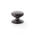 Alexander & Wilks Waltz Round Cupboard Knob on Stepped Rose in an oil-rubbed bronze finish, featuring a smooth round knob atop a stepped rose base.