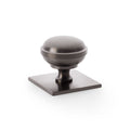 Alexander & Wilks Quantock Cupboard Knob on Square Backplate featuring a rounded knob design in a brushed metal finish, mounted on a square backplate.