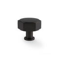 Alexander & Wilks Vesper Hex Cabinet Knob in a matte black finish, featuring a hexagonal shape and a sturdy base for easy grip.