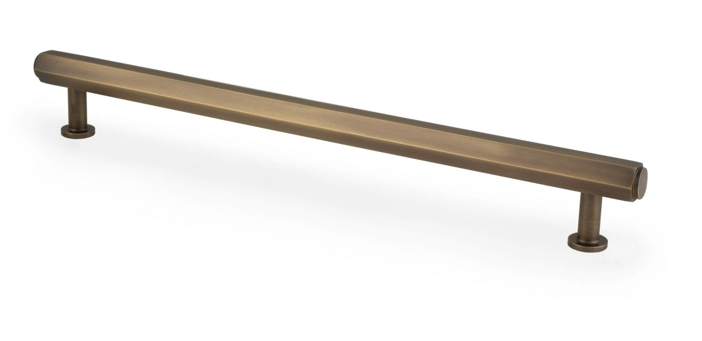 Alexander & Wilks Vesper Hex T-Bar Cabinet Pull in a brushed bronze finish, featuring a straight cylindrical design with two rounded ends for easy grip.