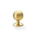 Alexander & Wilks Caesar Cupboard Knob on Round Rose in a brushed brass finish, featuring a spherical design with horizontal grooves and a round base.