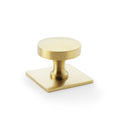 Alexander & Wilks Bullion Cupboard Knob on Square Backplate in brushed brass finish, featuring a round knob atop a square backplate, suitable for cabinetry and furniture.
