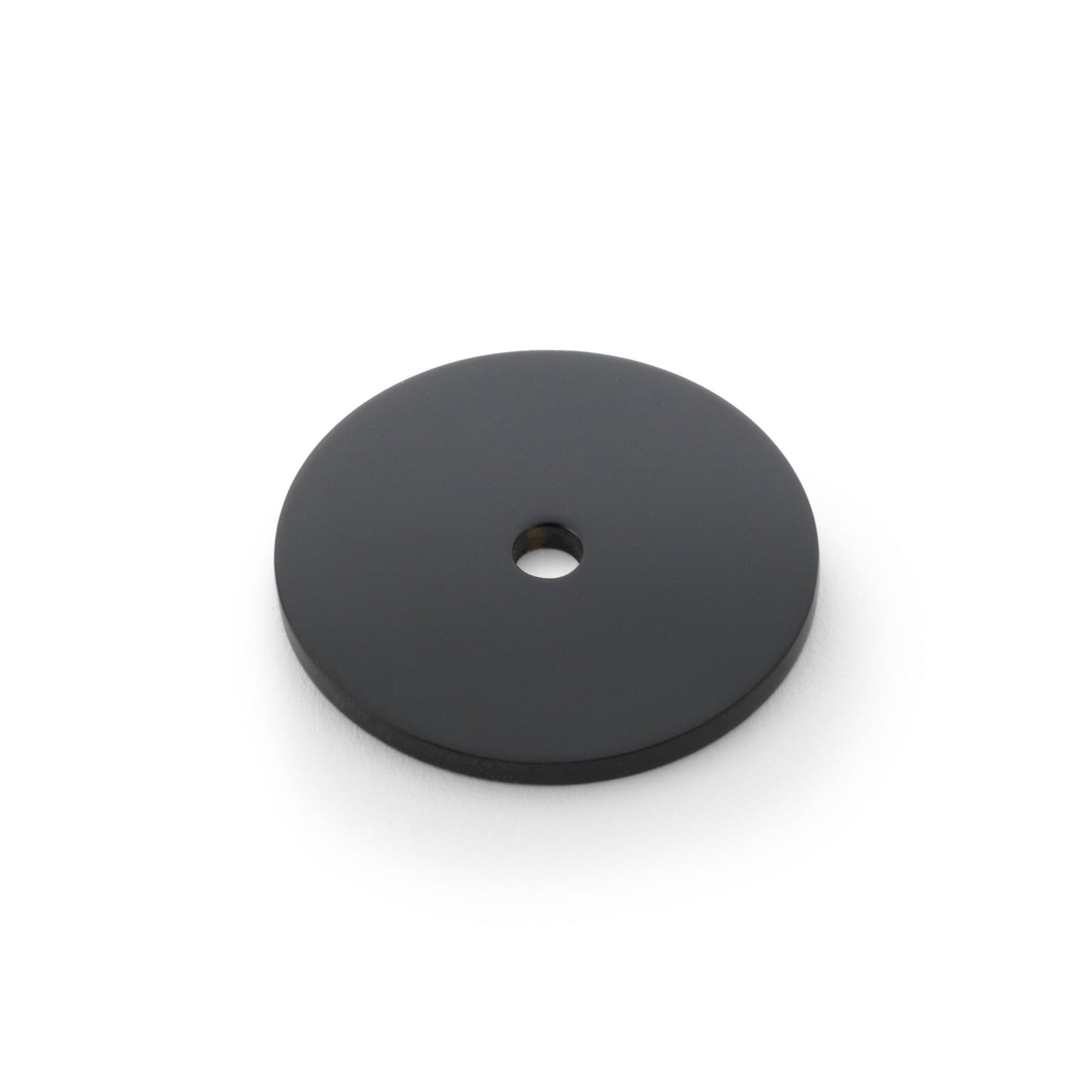 Alexander & Wilks Circular Backplate in black, featuring a flat circular design with a central hole for mounting or fitting purposes.