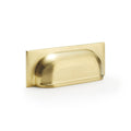 Alexander & Wilks Quantock Cup Handle in a brushed brass finish, featuring a smooth curved design and a rectangular backplate, suitable for cabinetry and drawers.