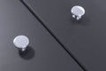 Carlisle Brass Oxford Knob in a polished chrome finish, featuring a round design and affixed to a dark surface.
