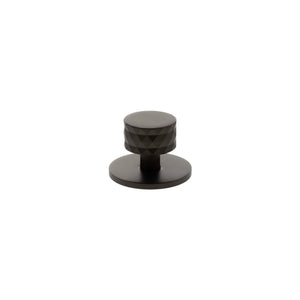 Atlantic Millhouse Brass Chrysler Diamond Round Cabinet Knob Handle on Backplate in a dark finish, featuring a diamond pattern on the knob and a circular backplate.