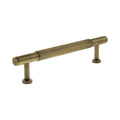 Atlantic Millhouse Brass Battersea Linear T-Bar Cabinet Pull Handle measuring 128mm, featuring a ribbed design and circular bases, finished in a warm brass tone.