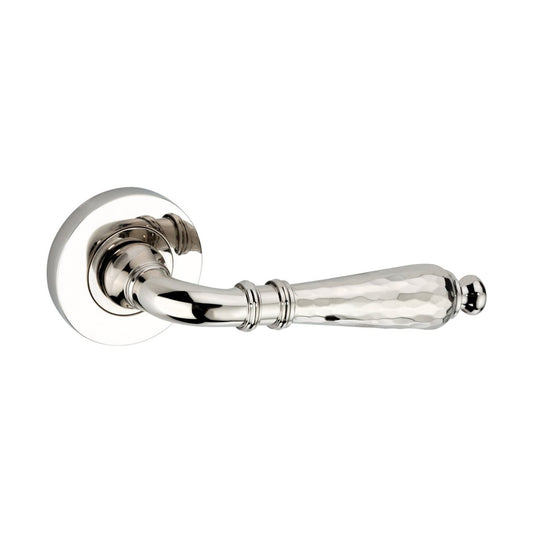 Spira Brass Hammered Hazel Lever on Rose features a polished chrome finish with a textured, hammered handle and a round rosette. The design combines elegance with durability, suitable for various interior doors.