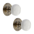Spira Brass Crackled Porcelain Mortice Door Knob featuring a white crackle finish, mounted on a round antique brass plate for a classic look.