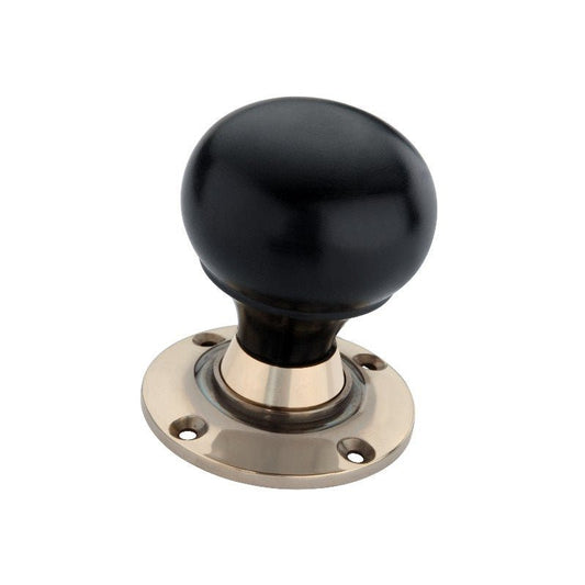 Spira Brass Ebony Bun Rim/Mortice Door Knob featuring a round black knob and a decorative brass base plate, showing visible mounting holes for installation.