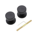Spira Brass Connaught Knurled Door Knob set in black, featuring a knurled texture and round shape. The set includes two knobs, a mounting pin, and a hex key for installation.