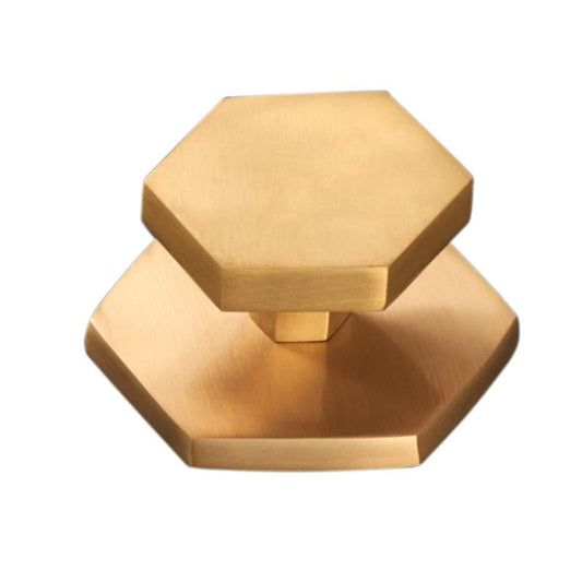 Spira Brass Hexagonal Centre Door Knob in a brushed gold finish, featuring a hexagonal shape with a smooth surface and an ample base for easy grip.