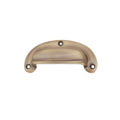 Spira Brass Traditional Cup Pull in a brushed brass finish, featuring an arched design and three mounting holes for installation.