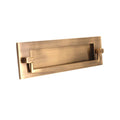 Spira Brass Regency Knocker Postal Plate 250mm in a brushed brass finish, featuring a rectangular design with a center slot and two side knobs.