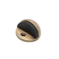 Spira Brass Half Moon Door Stopper featuring a half-moon design with a black rubber insert and a brass finish. The door stopper has a circular base with a mounting hole for secure installation.