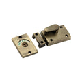 Spira Brass Indicator Bolt Latch in antique brass finish, featuring a thumb turn and a rectangular plate displaying 'VACANT.' The latch design includes mounting holes for easy installation.