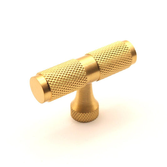 Spira Brass Knurled T Bar Cupboard Pull in gold finish, featuring a textured grip on the handles and a rounded base. The pull has a sleek design suited for cupboard doors.