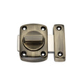 Spira Brass Sigma Bathroom Latch Small in an antique brass finish, featuring a round knob mechanism and a rectangular strike plate, suitable for securing bathroom doors.
