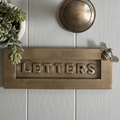 Brass bee Letterplate by Brass bee in a brushed brass finish, featuring the word "LETTERS" embossed on a textured background and including a decorative bee design on the side.