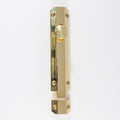 Carlisle Brass Surface Bolt in a polished gold finish, featuring a cylindrical knob and a rectangular plate, designed for secure door fastening.