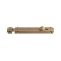 Carlisle Brass Surface Bolt in a brass finish, featuring a long rectangular body and a rounded knob, designed for securing doors and windows.