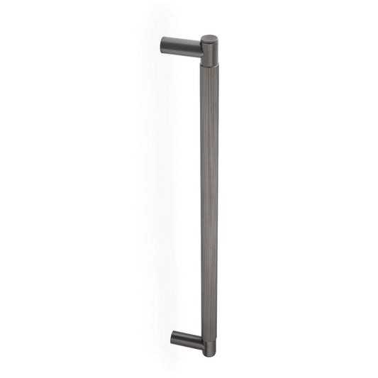 Alexander & Wilks Spitfire Reeded Pull Handle in a dark metallic finish, featuring a sleek design with reeded texture, and cylindrical ends for grip.