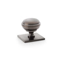 Alexander & Wilks Quantock Cupboard Knob on Square Backplate in an antique bronze finish, featuring a rounded knob design mounted on a square base for a classic look.