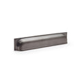 Alexander & Wilks Quantock Cup Handle in a dark finish, featuring a smooth, curved design that extends across a rectangular base for easy grip.