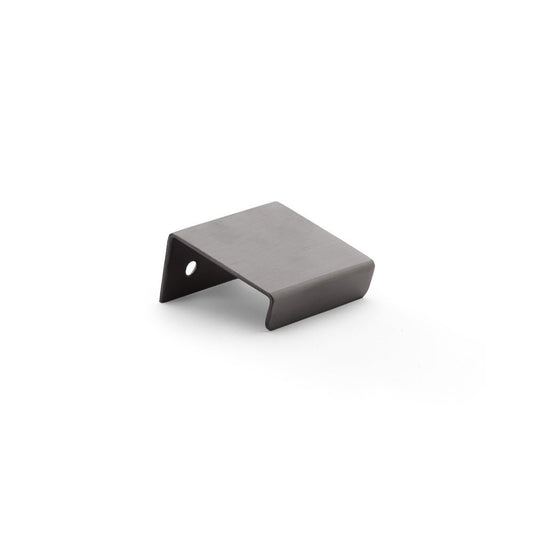 Alexander & Wilks Tilly Finger Pull in a dark finish, featuring a simple, angular design with a hole for mounting. The pull is made of metal and is suitable for various cabinetry applications.