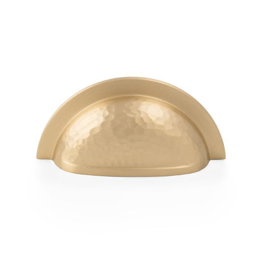 Alexander & Wilks Bardom Hammered Ridged Cup Pull in a gold finish, featuring a hammered ridged design and a half-moon shape, suitable for cabinetry and furniture applications.