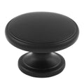 Carlisle Brass Oxford Knob in black finish, featuring a round, smooth design and a slightly raised surface, designed for cabinets and drawers.