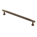 Carlisle Brass Lines Pull Handle Range in an antique bronze finish, featuring a grooved design for grip and installing on two round bases.
